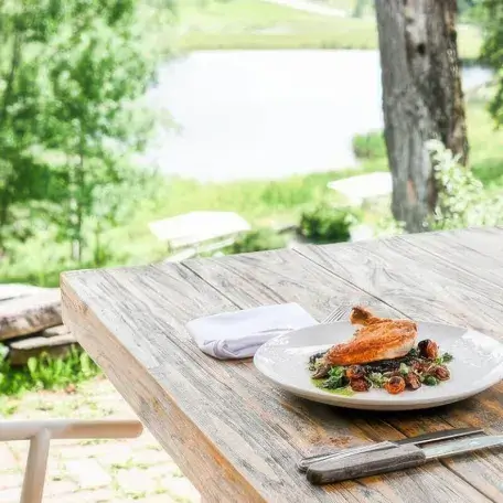 an outdoor table with a plate of food on it