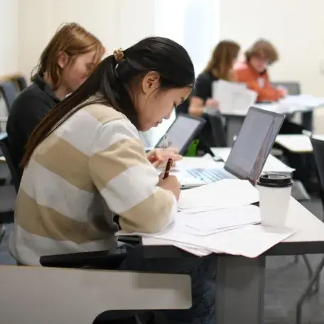 A few UVM students in a class working in pairs
