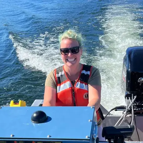 Rose Stuart driving a boat.