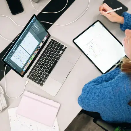 A student working on her laptop above view