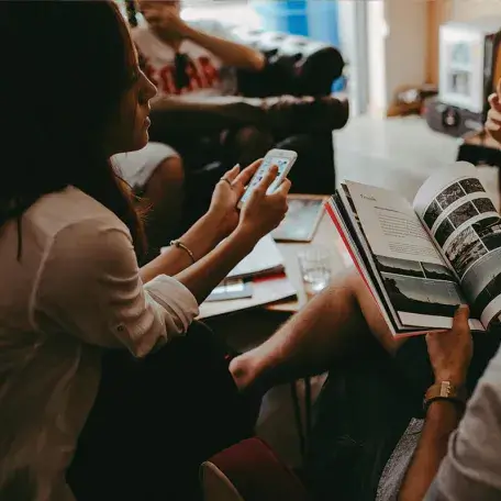 a small group of people sitting with each other indoors