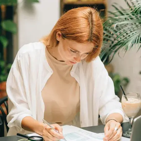 person at a desk looking down at some paperwork