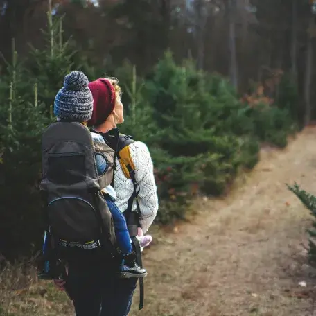 parent and child hiking on a trail