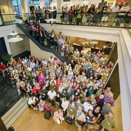 dozens of conference attendees gathered indoors