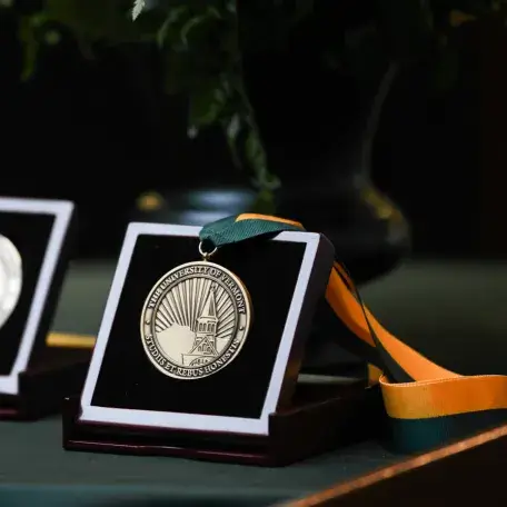 Award with ribbon on a table links to Center Accomplishments Page