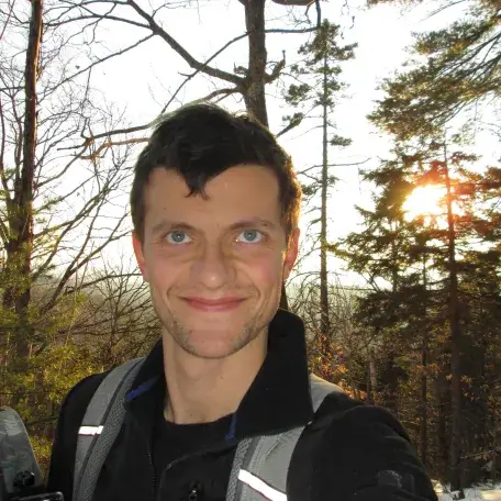 Headshot of Connor Stedman, with snowy woods in the background