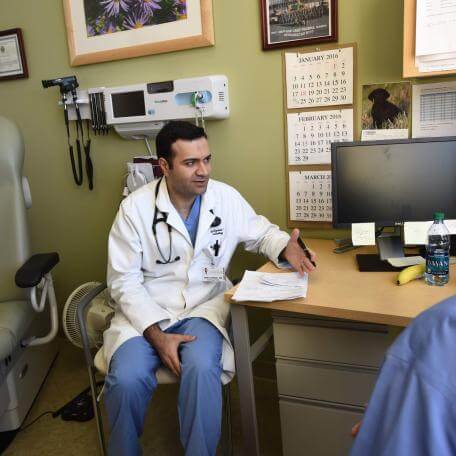 Doctor sitting and speaking to a patient