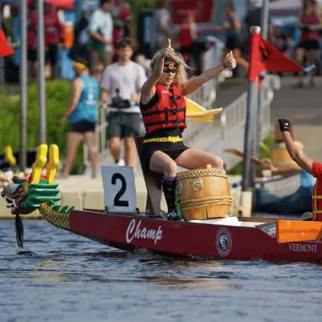 Two women on a dragonboat cheering