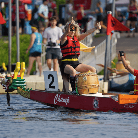 Two women on a dragonboat cheering