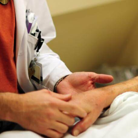 Doctor holding patients hand