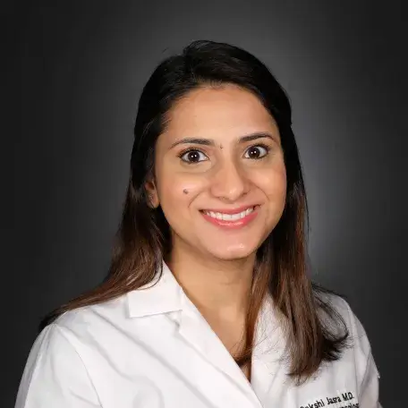 A person wearing a white coat