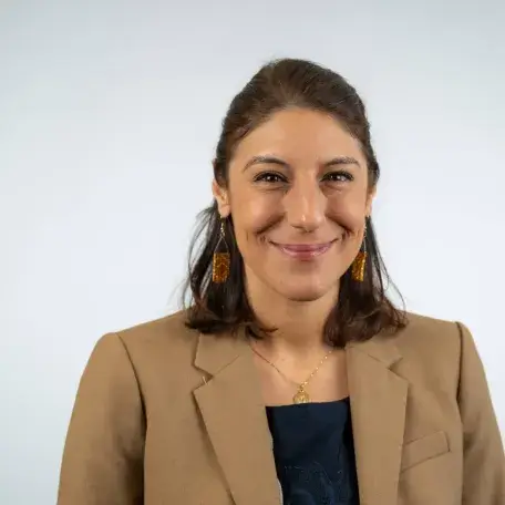  A person with brown hair and a brown blazer