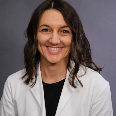 A person wearing a white coat
