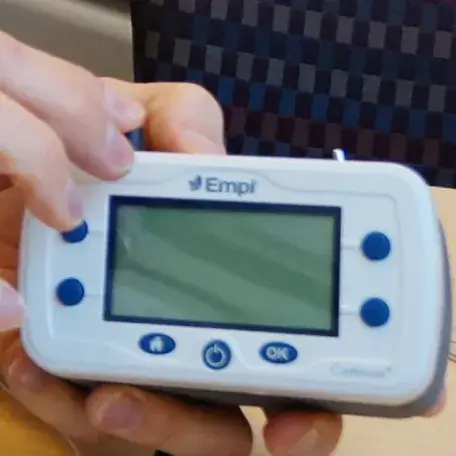 close of hands holding a biomedical device