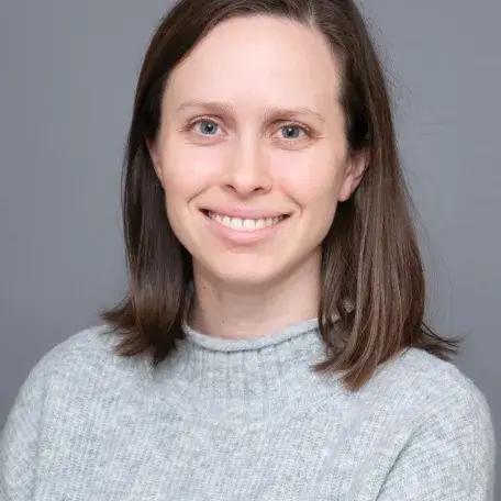 A person wearing a gray sweater
