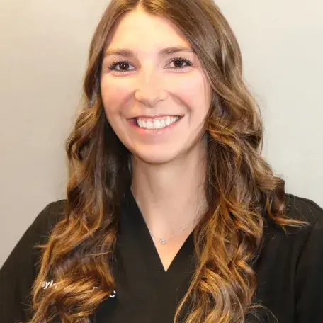 A person with brown hair wearing a black shirt
