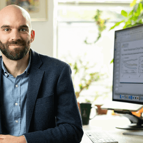 a man near a computer in an office