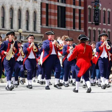 The vrass section of a big marching band performs at the 2023 Loyalty Parade.