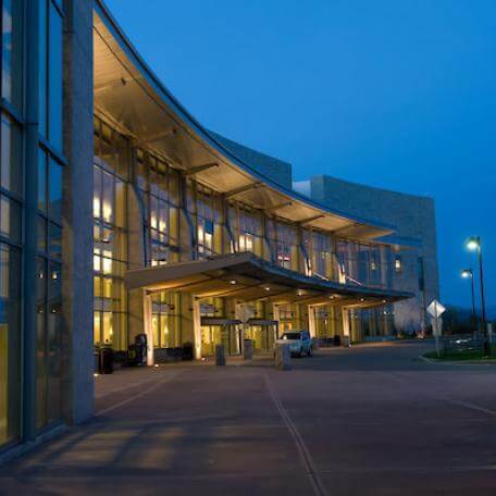 Three story curved building lighted at night 