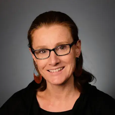 A person wearing a black shirt and glasses
