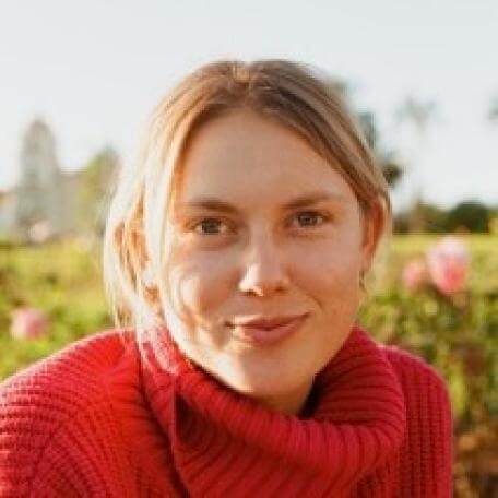 Darian in front of a flower garden