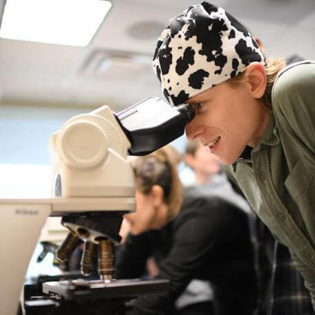 A person looking in a microscope