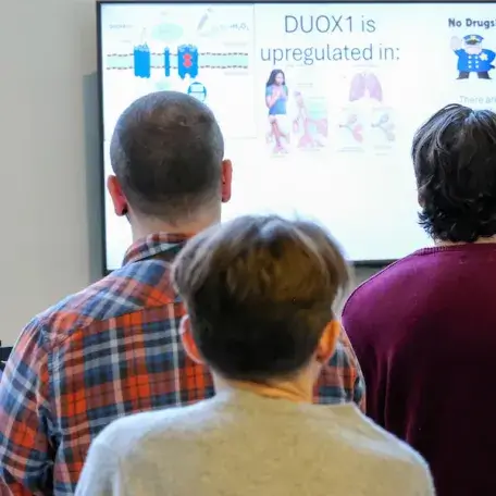 Pathology personnel watching a video presentation on Redox research