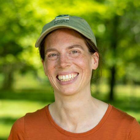 Sonia smiling in a baseball cap