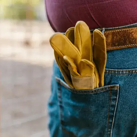 closeup of gloves in someone's back pocket