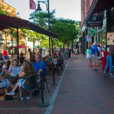 People sitting in outdoor seats of restaurants