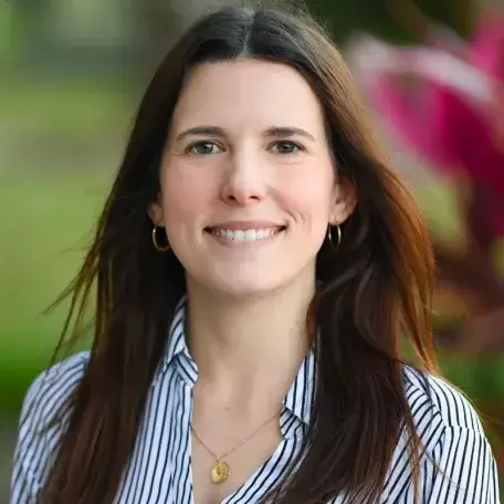 Hannah Pottgeiser is a white woman with long, brown hair