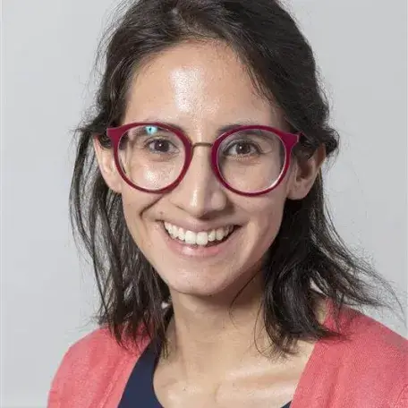 women with glasses smiles at camera