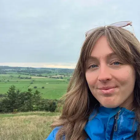 Headshot of Margaret with English countryside in background