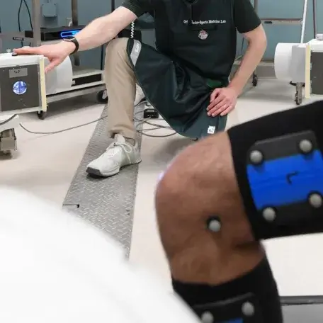 person taking an images of a persons knee