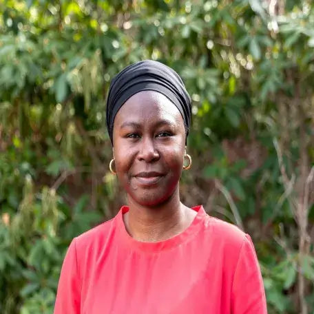 A woman stares into the camera.