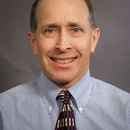 A person wearing a dress shirt and a tie