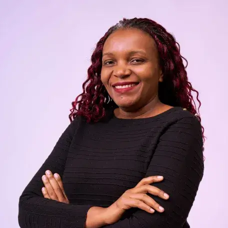 A woman with a dark dress against a purple background