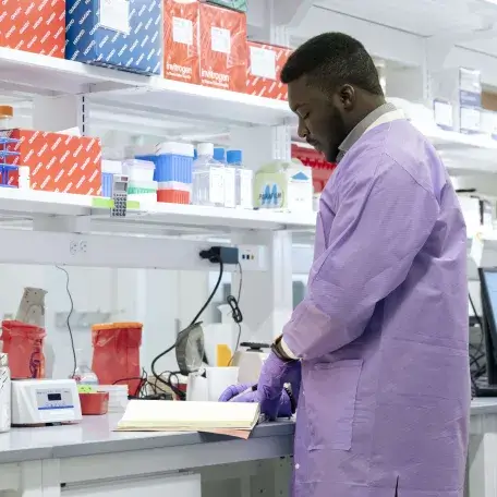 Scientist reading from notebook