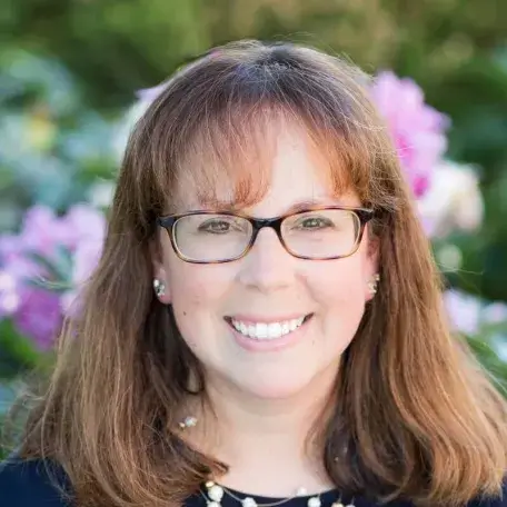 woman with glasses smiling