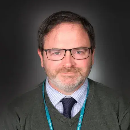 man with glasses smiling