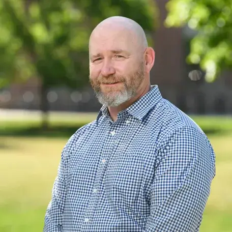 man with beard wearing a blue shirt