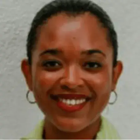A person wearing earrings and a collared shirt