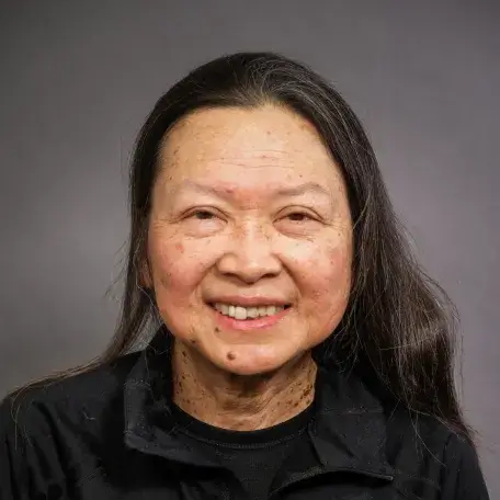 light skinned woman with long brown hair and a black shirt