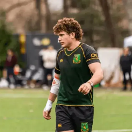 A young man playing Rugby