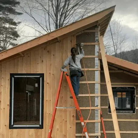 A young woman building a house