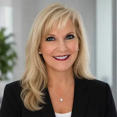 blond woman smiling wearing a black jacket