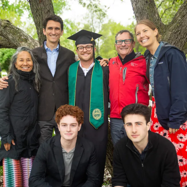 A graduate surrounded by his family.