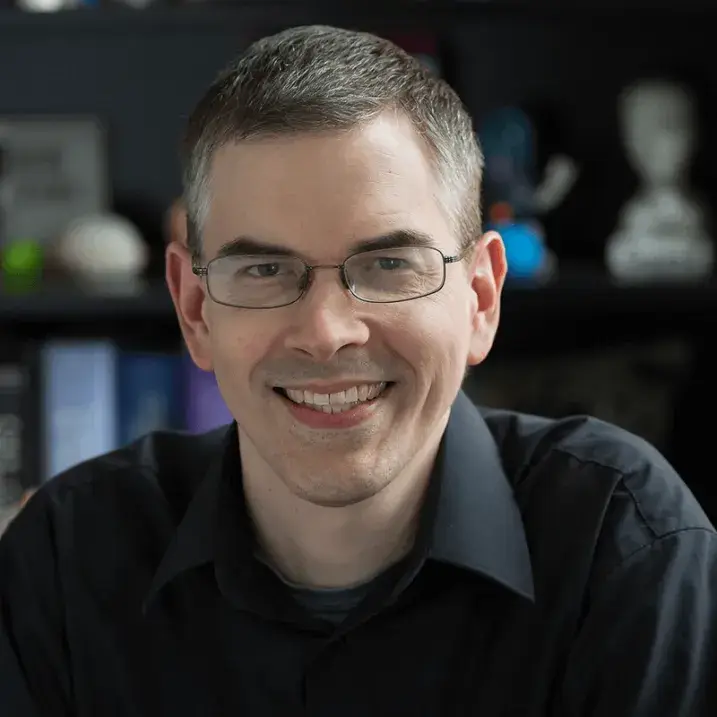 Keith, smiling for the camera in an office type setting