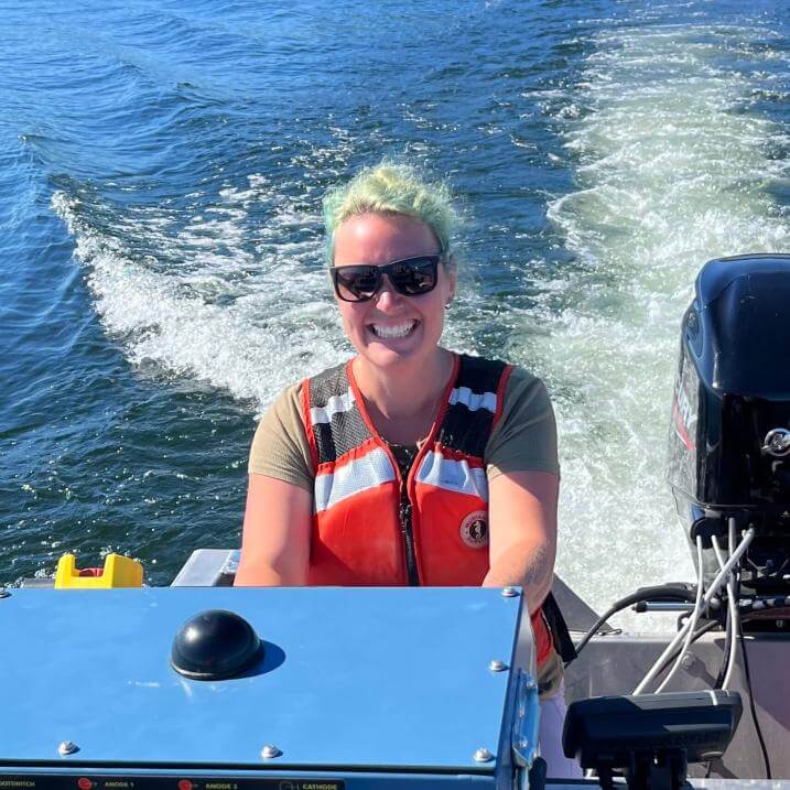 Rose Stuart driving a boat.