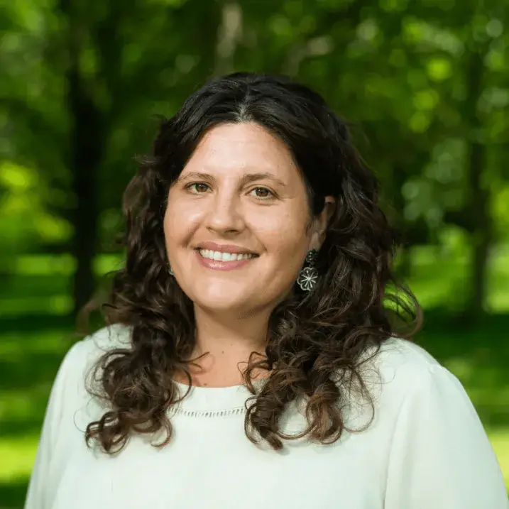 Headshot of Margot Smithson in front of green trees